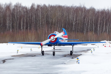 Small plane at the airport in winter