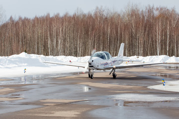 Small plane at the airport in winter