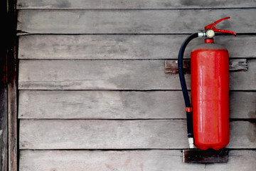 Fire extinguisher on wooden wall