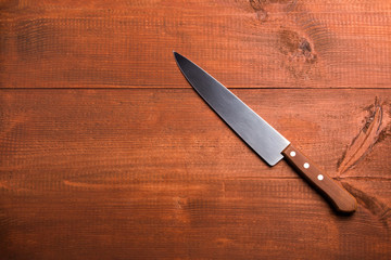 Kitchen knife on the wooden table