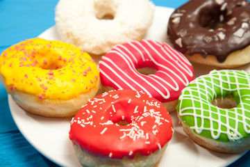 Colorful donuts on a blue table