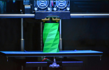 3D printer works and creates an object from the hot molten plastic close-up. Automatic three...