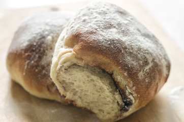 Buns with poppy seeds on wooden background