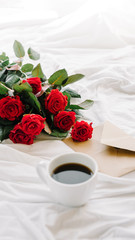 cup of coffee and a bouquet of red roses, envelope