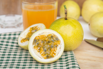 passion fruit and Juice in glass on wood table