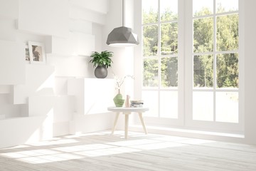 White room with table and green landscape in window. Scandinavian interior design