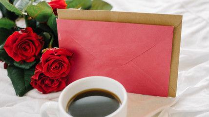 cup of coffee and a bouquet of red roses, envelope