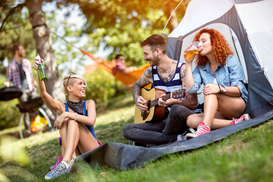 Youth enjoys with guitar and songs at summer camp