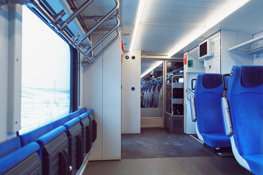 Fototapeta The interior of carriage with seats for passengers and their bicycles in high-speed commuter train.