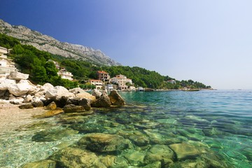 Beautiful holiday landscape of rocky beach, sea and mountains