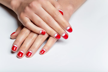 Fototapeta premium Female hands with red and white nails