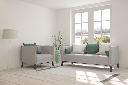 White room with sofa and urban landscape in window. Scandinavian interior design