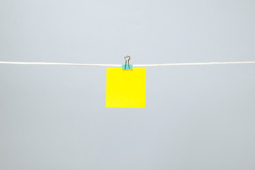 Blank yellow paper note on the string