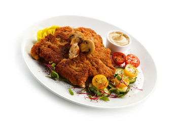 Fried pork chop, French fries and vegetables 