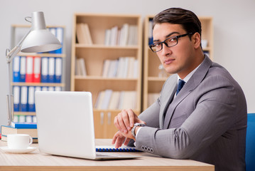 Young handsome businessman working on office