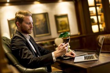 Young man working in the room with vintage furniture