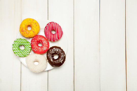 Doughnuts on a white wooden table