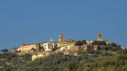 Fototapeta na wymiar Beautiful panorama of the medieval village of Montepescali overlooking the whole hill and the forest below, Grosseto, Tuscany, Italy