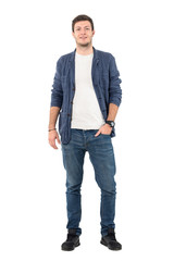 Happy smiling man in jeans and denim shirt with hand in pocket looking at camera. Full body length portrait isolated over white background.
