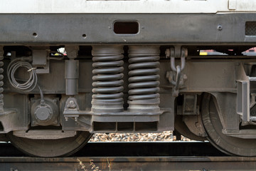 Close up detail of Suspension, shock absorber and wheels freight wagon - Diesel railcar