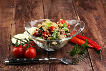 Delicious vegetarian quinoa salad with bell pepper, cucumber and tomatoes