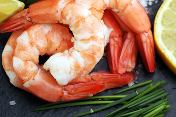 Delicious sauteed shrimp heart with cajun seasoning and lime on dark stone