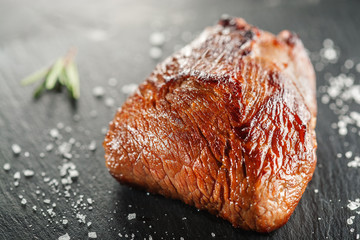 grilled steak with rosemary on a  wooden background