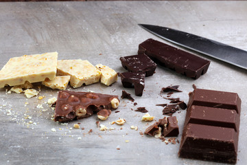 Melting chocolate and diffrent bars - stack and chips with chocolate swirl/ powder and cocoa pod with melted chocolate