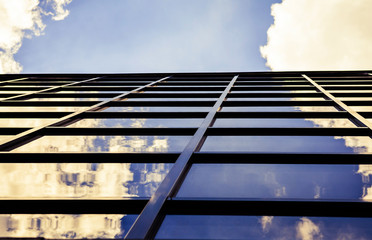 Photo of the glass facade of the building against the blue sky