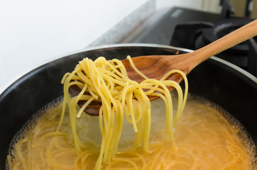Spaghetti cooking in hot water