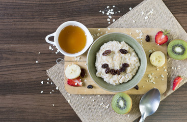 Fototapeta na wymiar Healthy food,oatmeal breakfast and fruit on wooden background top view close up