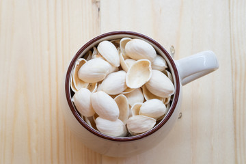 Pistachio shell in cup on the table