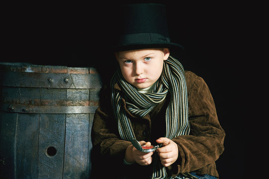 retro portrait of a boy in a top hat and pocket watch