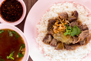 Thailand style rice braised pork and soup on wooded backgound