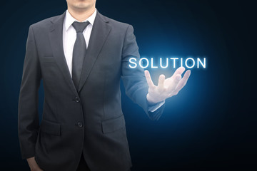 Professional businessman in blue tone background hold SOLUTION on hand in business concept