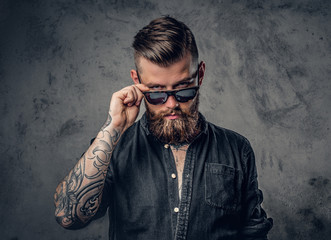 A man with tatoos on his arms.