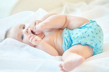 small baby playing with his leg