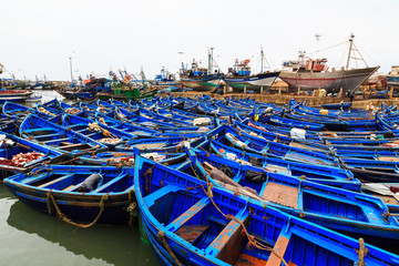Fototapeta na wymiar Small blue fishing boats in the harbor of Essaouira