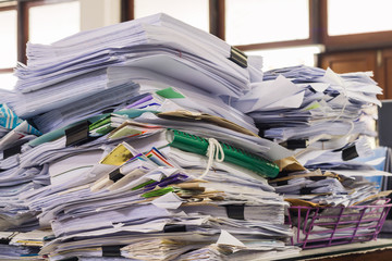 Pile of documents on desk at workplace