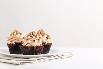 Tasty cupcakes on a white wooden table