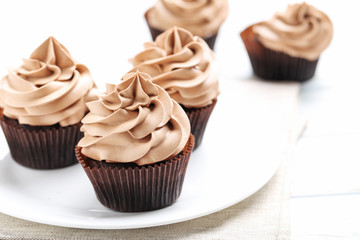 Tasty cupcakes on a white wooden table