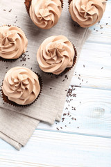 Tasty cupcakes on a white wooden table