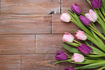 Bouquet of tulips on a brown wooden table