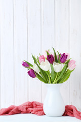 Bouquet of tulips on a wall paneling background