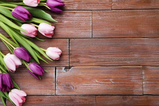 Bouquet of tulips on a brown wooden table
