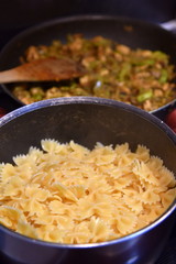farfalle pasta cooking in pan