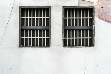 Jail's window on white wall