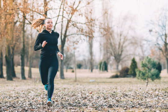 Young Woman Running In The Park  