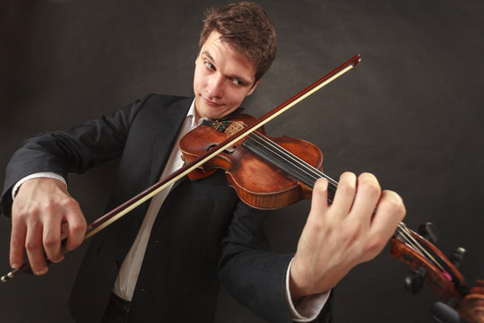 Man playing violin showing emotions and expressions