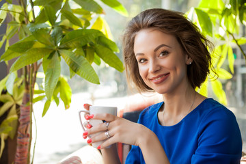 Woman drinking coffe in a coffee shop